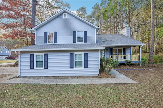 view of front of property with covered porch and a front yard