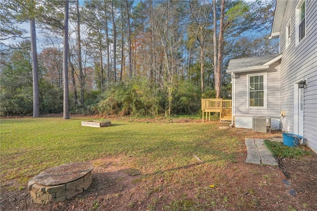 view of yard with cooling unit and a wooden deck