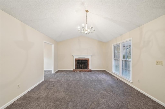 unfurnished living room with dark colored carpet, a chandelier, a textured ceiling, vaulted ceiling, and a fireplace