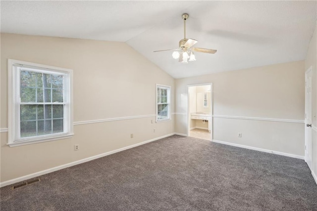 carpeted empty room with ceiling fan and vaulted ceiling