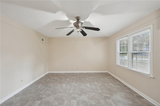 spare room with ceiling fan