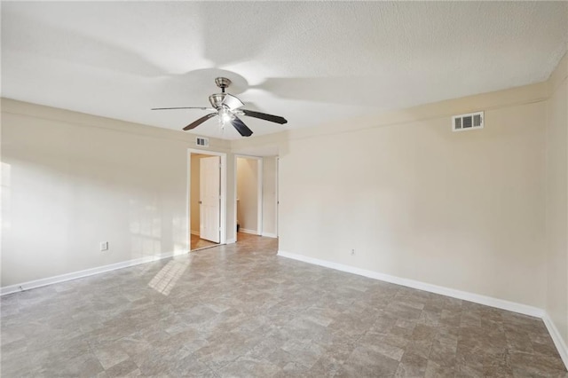 unfurnished room with ceiling fan and a textured ceiling