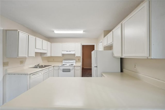 kitchen featuring kitchen peninsula, white cabinetry, white appliances, and sink