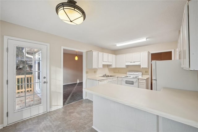 kitchen with white cabinets, white appliances, and kitchen peninsula