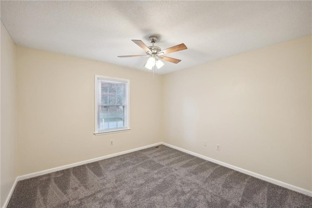 carpeted spare room with ceiling fan and a textured ceiling