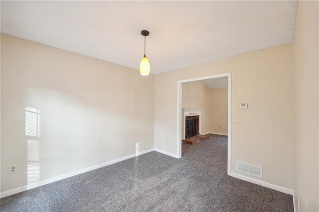 unfurnished room with dark colored carpet