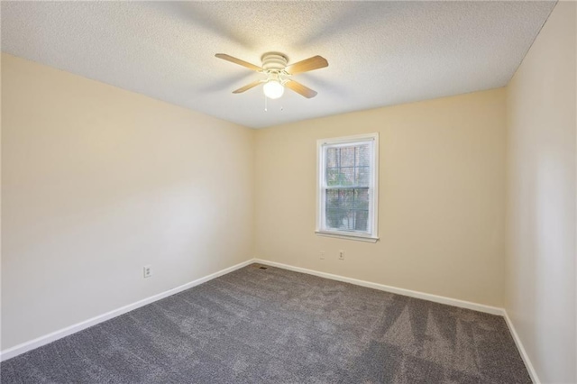 carpeted empty room featuring ceiling fan and a textured ceiling