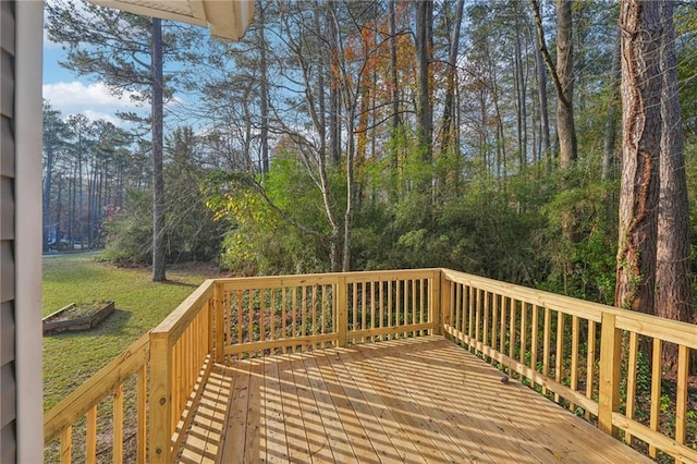 wooden deck featuring a lawn