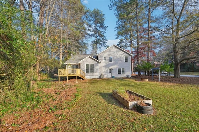 rear view of house with a lawn and a deck