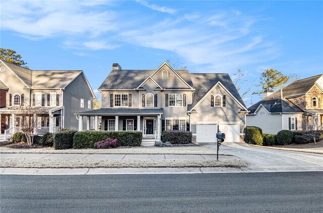 view of front of house with a porch and a garage