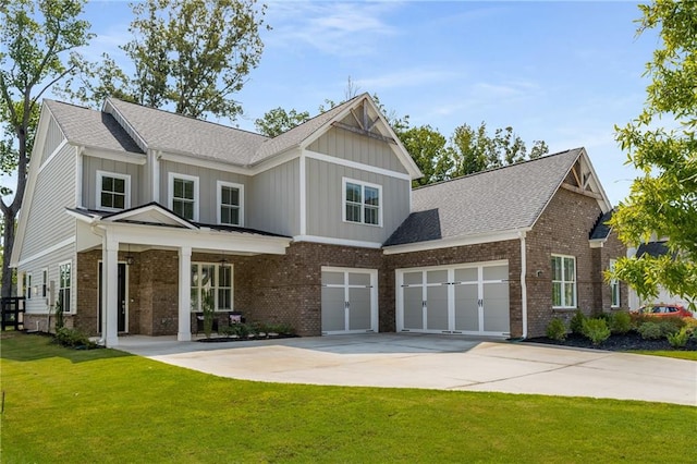 craftsman house with a garage and a front lawn