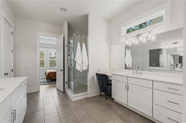 bathroom featuring vanity, tile patterned floors, a wealth of natural light, and an enclosed shower