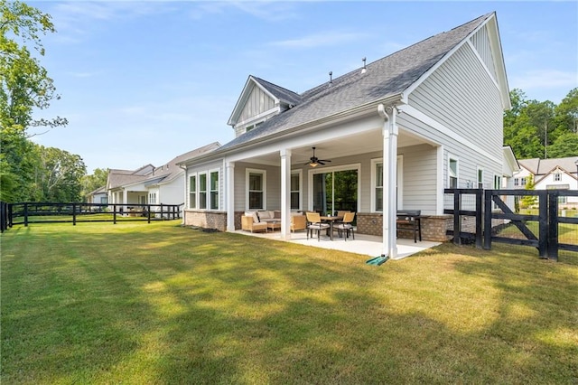 back of property featuring a patio area, an outdoor living space, a yard, and ceiling fan