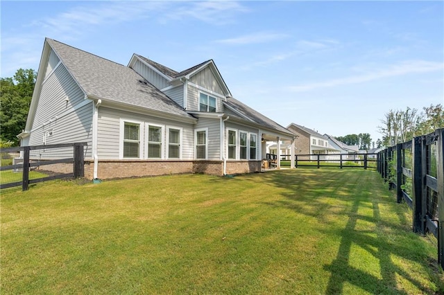 rear view of house with a lawn