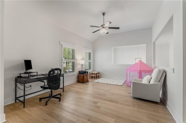 office space featuring ceiling fan, lofted ceiling, and light hardwood / wood-style floors