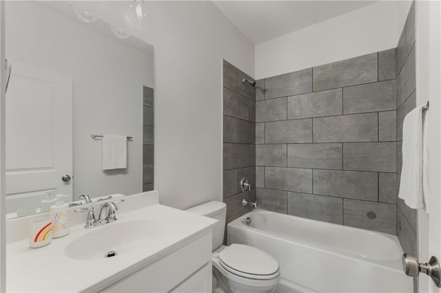 full bathroom featuring vanity, tiled shower / bath combo, and toilet