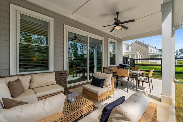 view of patio with an outdoor living space and ceiling fan