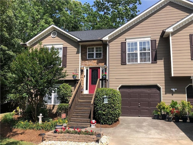 1784 Virginia Grove Ln, Lawrenceville, GA 30045 - raised ranch featuring a garage, concrete driveway, and stone siding