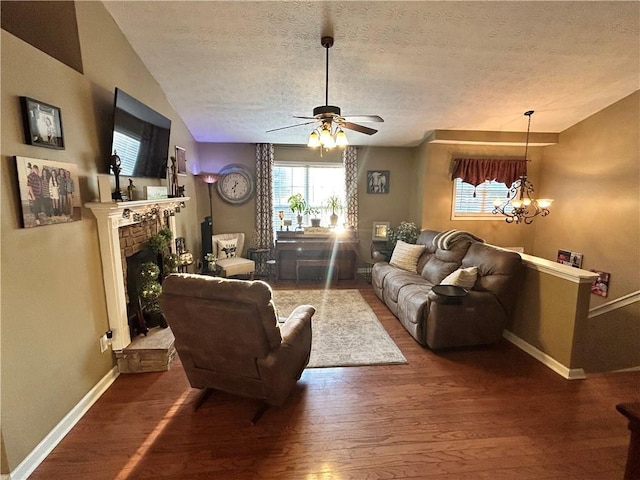1784 Virginia Grove Ln, Lawrenceville, GA 30045 - living room featuring wood finished floors, a textured ceiling, ceiling fan, a fireplace with raised hearth, and a chandelier