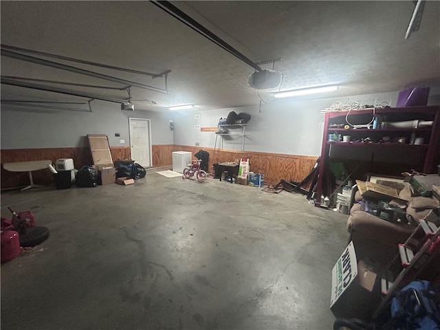 1784 Virginia Grove Ln, Lawrenceville, GA 30045 - garage featuring a wainscoted wall, a garage door opener, and wooden walls