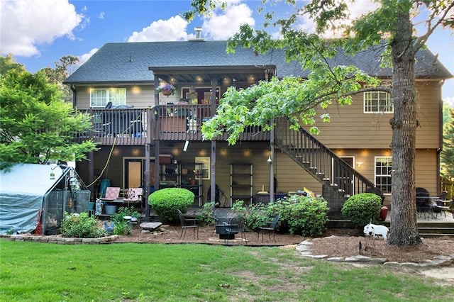 1784 Virginia Grove Ln, Lawrenceville, GA 30045 - back of property with a deck, a lawn, stairs, and a shingled roof