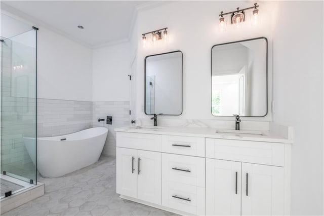 bathroom with shower with separate bathtub, tile walls, tile patterned floors, ornamental molding, and vanity