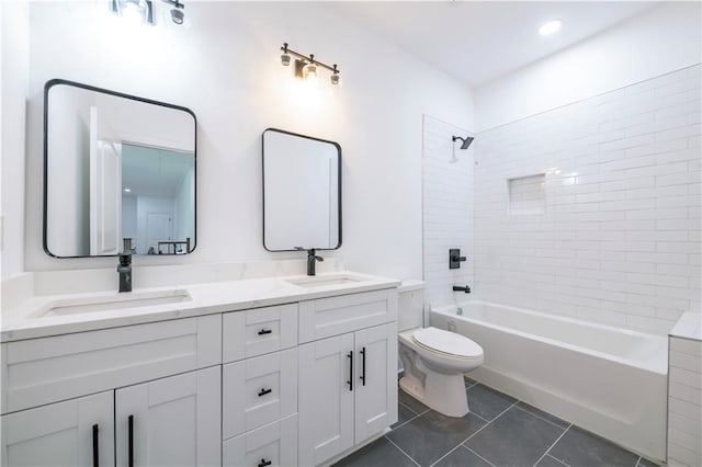 full bathroom with toilet, tile patterned flooring, tiled shower / bath, and vanity