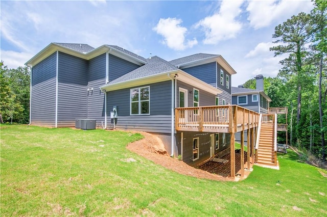 back of house featuring cooling unit, a deck, and a yard