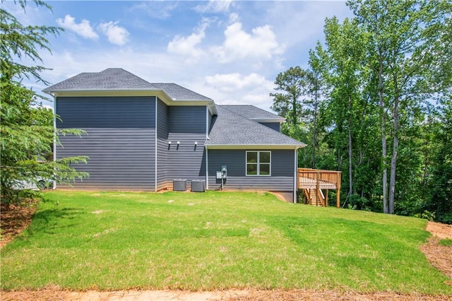 back of house featuring a deck and a yard