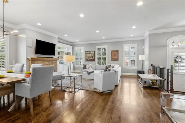 2362 Saint Davids Sq NW, Kennesaw, GA 30152 - living room featuring wood finished floors, ornamental molding, recessed lighting, healthy amount of natural light, and a chandelier