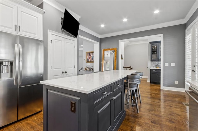 2362 Saint Davids Sq NW, Kennesaw, GA 30152 - kitchen with stainless steel refrigerator with ice dispenser, crown molding, white cabinetry, a kitchen island, and a breakfast bar area