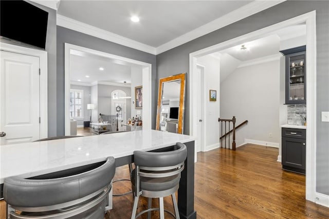 2362 Saint Davids Sq NW, Kennesaw, GA 30152 - kitchen featuring dark wood finished floors, crown molding, glass insert cabinets, light stone countertops, and baseboards