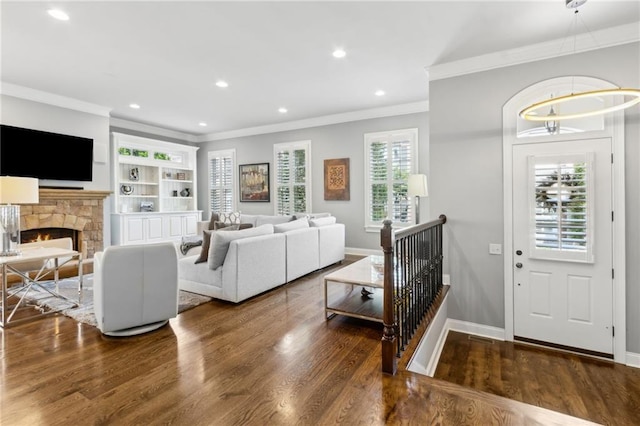 2362 Saint Davids Sq NW, Kennesaw, GA 30152 - living room with crown molding, wood finished floors, recessed lighting, a stone fireplace, and baseboards