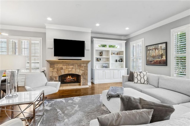 2362 Saint Davids Sq NW, Kennesaw, GA 30152 - living room featuring ornamental molding, wood finished floors, a stone fireplace, and recessed lighting