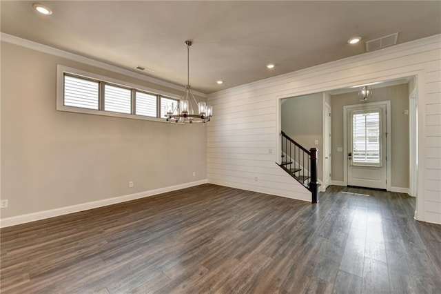 spare room featuring dark wood-style floors, stairway, visible vents, and a notable chandelier