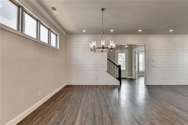 unfurnished dining area featuring dark wood-style floors, a chandelier, visible vents, and plenty of natural light