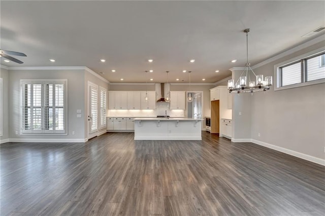 unfurnished living room with crown molding, dark wood finished floors, recessed lighting, visible vents, and baseboards