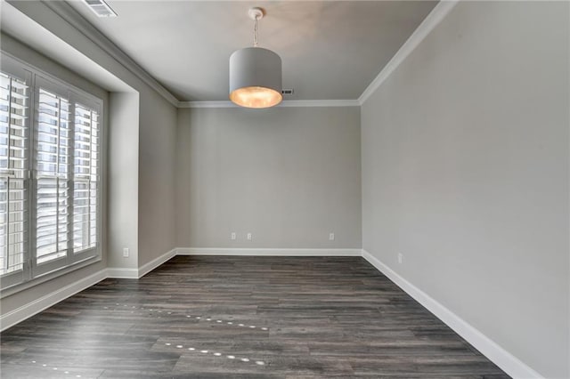 empty room featuring ornamental molding, plenty of natural light, and wood finished floors