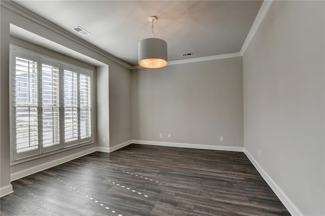 empty room featuring baseboards, visible vents, crown molding, and wood finished floors