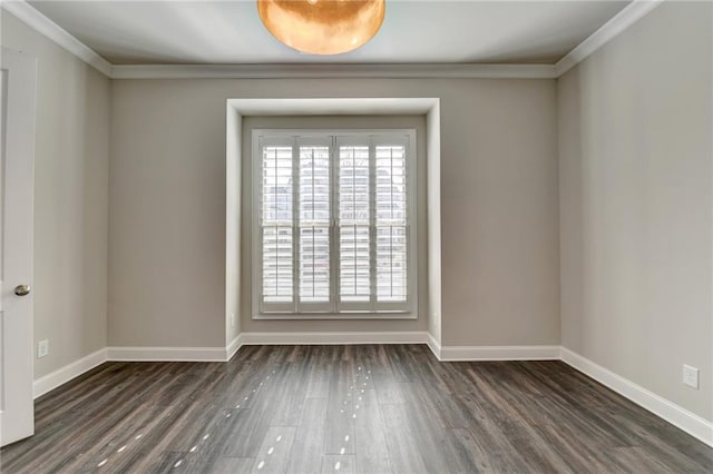 empty room featuring dark wood-style floors, crown molding, and baseboards