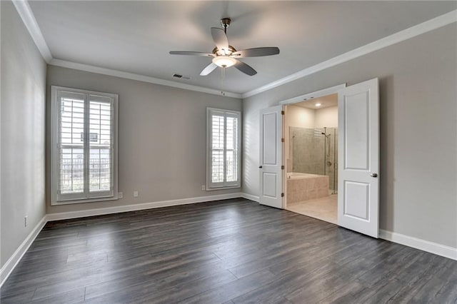 unfurnished bedroom featuring crown molding, visible vents, dark wood finished floors, and baseboards