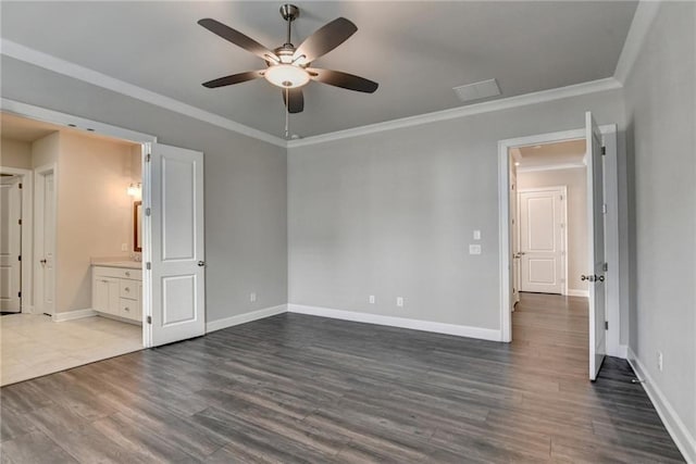 unfurnished bedroom with dark wood-type flooring, ornamental molding, and baseboards