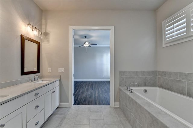 full bath with double vanity, ceiling fan, a garden tub, tile patterned flooring, and a sink