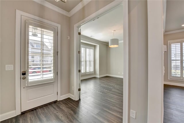 doorway with baseboards, ornamental molding, and dark wood-type flooring