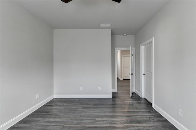 interior space with dark wood-style floors, visible vents, and baseboards