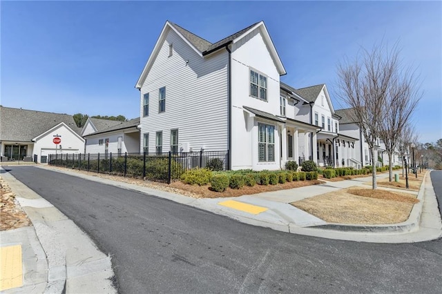 view of property exterior with a residential view and fence