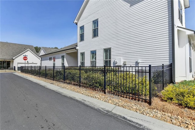 view of home's exterior with fence