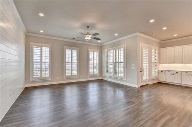 unfurnished living room with crown molding, baseboards, dark wood-type flooring, and recessed lighting