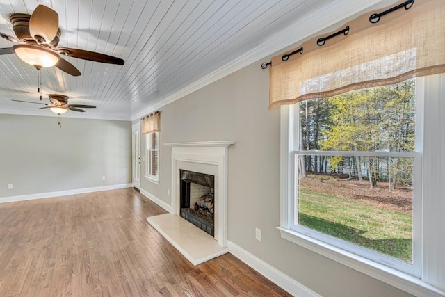 3464 Maynard Cir, Gainesville, GA 30506 - unfurnished living room with a fireplace with raised hearth, a ceiling fan, wood ceiling, wood finished floors, and crown molding
