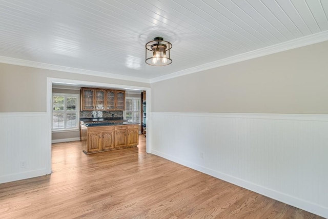 3464 Maynard Cir, Gainesville, GA 30506 - unfurnished living room featuring a wainscoted wall, ornamental molding, and light wood-style flooring
